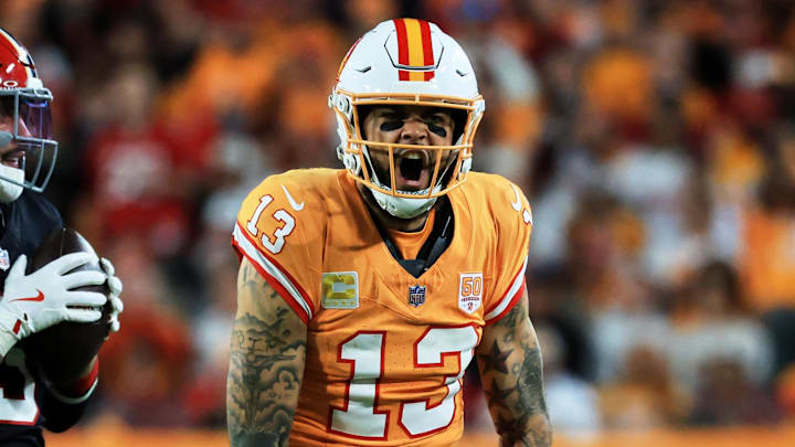 Dec 11, 2025; Tampa, Florida, USA; Tampa Bay Buccaneers wide receiver Mike Evans (13) reacts after catching a pass against Atlanta Falcons safety Jessie Bates III (3) (obscured) during the third quarter at Raymond James Stadium. Mandatory Credit: Kim Klement Neitzel-Imagn Images