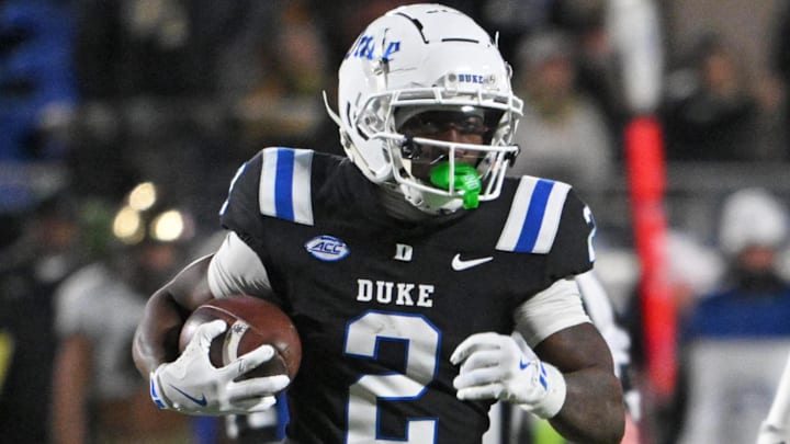 Nov 29, 2025; Durham, North Carolina, USA;  Duke Blue Devils wide receiver Sahmir Hagans (2) runs the ball against Wake Forest Demon Deacons linebacker Whittman Whaley (40) during the fourth quarter at Wallace Wade Stadium. Mandatory Credit: Zachary Taft-Imagn Images