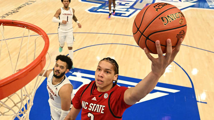 Mar 12, 2026; Charlotte, NC, USA; NC State Wolfpack guard Matt Able (3) scores as Virginia Cavaliers forward Devin Tillis (11) defends in the first half at Spectrum Center. Mandatory Credit: Bob Donnan-Imagn Images