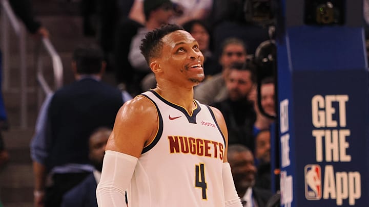 Mar 17, 2025; San Francisco, California, USA; Denver Nuggets guard Russell Westbrook (4) smiles ahead of a sign reading “Russ” after a play against the Golden State Warriors during the fourth quarter at Chase Center. Mandatory Credit: Kelley L Cox-Imagn Images Mar 17, 2025; San Francisco, California, USA; Denver Nuggets guard Russell Westbrook (4) smiles ahead of a sign reading “Russ” after a play against the Golden State Warriors during the fourth quarter at Chase Center. Mandatory Credit: Kelley L Cox-Imagn Images