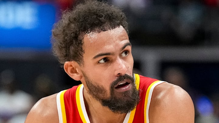 Trae Young #11 of the Atlanta Hawks rests between possessions against the Detroit Pistons.