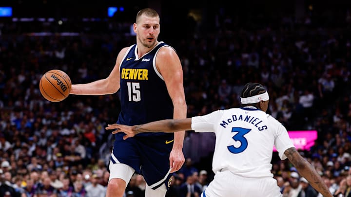 Apr 27, 2026; Denver, Colorado, USA; Denver Nuggets center Nikola Jokic (15) controls the ball as Minnesota Timberwolves forward Jaden McDaniels (3) defends in the third quarter during game five of the first round of the 2026 NBA Playoffs at Ball Arena. Mandatory Credit: Isaiah J. Downing-Imagn Images