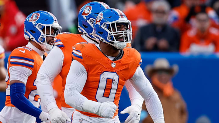 Jan 5, 2025; Denver, Colorado, USA; Denver Broncos linebacker Jonathon Cooper (0) reacts ahead of teammates after a sack in the second quarter against the Kansas City Chiefs at Empower Field at Mile High. 