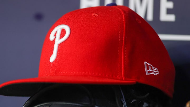 May 26, 2023; Atlanta, Georgia, USA; A detailed view of a Philadelphia Phillies hat and glove on the bench against the Atlanta Braves in the seventh inning at Truist Park. 