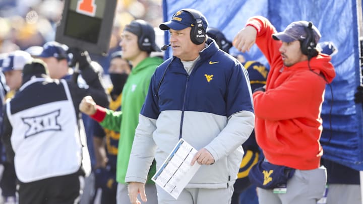 Nov 29, 2025; Morgantown, West Virginia, USA; West Virginia Mountaineers head coach Rich Rodriguez walks along the sidelines during the first quarter against the Texas Tech Red Raiders at Milan Puskar Stadium. Mandatory Credit: Ben Queen-Imagn Images Nov 29, 2025; Morgantown, West Virginia, USA; West Virginia Mountaineers head coach Rich Rodriguez walks along the sidelines during the first quarter against the Texas Tech Red Raiders at Milan Puskar Stadium. Mandatory Credit: Ben Queen-Imagn Images