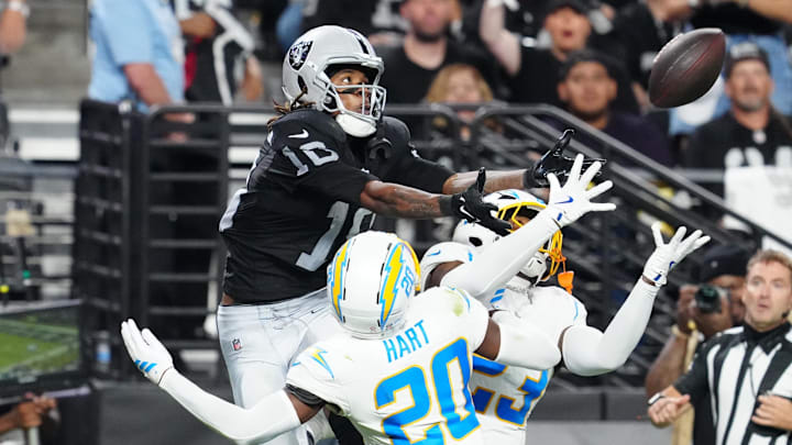 Sep 15, 2025; Paradise, Nevada, USA; Las Vegas Raiders wide receiver Dont'e Thornton Jr. (10) attempts to make a catch as Los Angeles Chargers cornerback Cam Hart (20) and Los Angeles Chargers safety Tony Jefferson (23) defend during the second quarter at Allegiant Stadium. Mandatory Credit: Stephen R. Sylvanie-Imagn Images