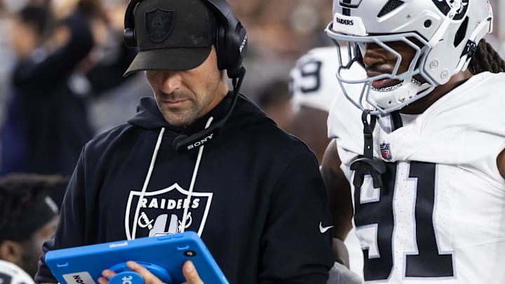 Aug 23, 2025; Glendale, Arizona, USA; Las Vegas Raiders defensive line coach Rob Leonard with defensive end Jahfari Harvey (91) against the Arizona Cardinals during a preseason NFL game at State Farm Stadium. Mandatory Credit: Mark J. Rebilas-Imagn Images