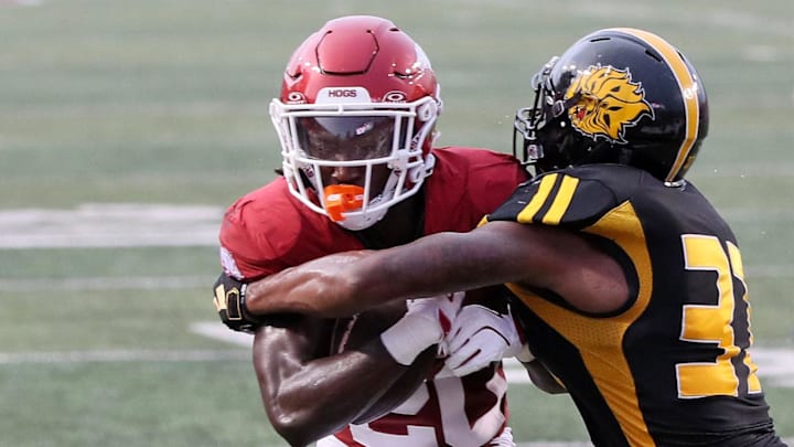 Arkansas Razorbacks running back Rodney Hill (20) rushes for a touchdown in the first quarter as Pine Bluff Golden Lions linebacker Jaylen White (31) defends at War Memorial Stadium. Mandatory Credit: Nelson Chenault-Imagn Images