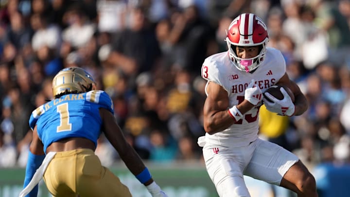 Sep 14, 2024; Pasadena, California, USA; Indiana Hoosiers wide receiver Elijah Sarratt (13) carries the ball against UCLA Bruins defensive back Kanye Clark (1) in the first half at Rose Bowl. Mandatory Credit: Kirby Lee-Imagn Images Sep 14, 2024; Pasadena, California, USA; Indiana Hoosiers wide receiver Elijah Sarratt (13) carries the ball against UCLA Bruins defensive back Kanye Clark (1) in the first half at Rose Bowl. Mandatory Credit: Kirby Lee-Imagn Images