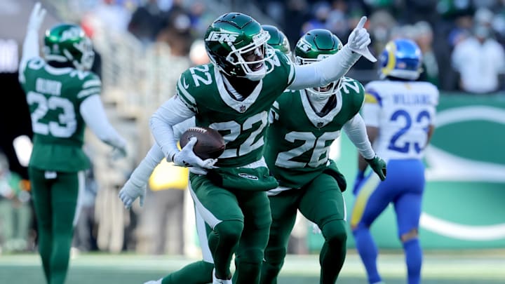 Dec 22, 2024; East Rutherford, New Jersey, USA; New York Jets safety Tony Adams (22) celebrates his interception against the Los Angeles Rams during the second quarter at MetLife Stadium. Mandatory Credit: Brad Penner-Imagn Images