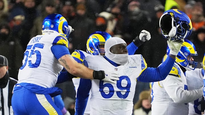 Jan 18, 2026; Chicago, IL, USA; Los Angeles Rams guard Kevin Dotson (69) celebrates with defensive end Braden Fiske (55) after defeating the Chicago Bears in overtime of an NFC Divisional Round game at Soldier Field. Mandatory Credit: David Banks-Imagn Images