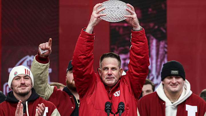 Indiana football coach Curt Cignetti lifts The Coaches' Trophy Jan. 24, 2026, at the Hoosiers' national championship celebration inside Memorial Stadium in Bloomington.