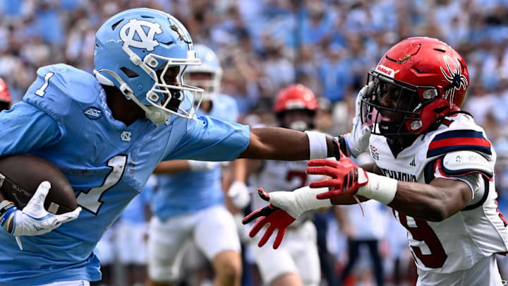 Sep 13, 2025; Chapel Hill, North Carolina, USA; North Carolina Tar Heels wide receiver Jordan Shipp (1) scores a touchdown as Richmond Spiders defensive back Lee Bruner IV (19) defends in the first quarter at Kenan Stadium. Sep 13, 2025; Chapel Hill, North Carolina, USA; North Carolina Tar Heels wide receiver Jordan Shipp (1) scores a touchdown as Richmond Spiders defensive back Lee Bruner IV (19) defends in the first quarter at Kenan Stadium.