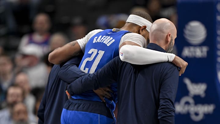 Feb 10, 2025; Dallas, Texas, USA; Dallas Mavericks center Daniel Gafford (21) is helped off the court during the second quarter against the Sacramento Kings at the American Airlines Center. Mandatory Credit: Jerome Miron-Imagn Images