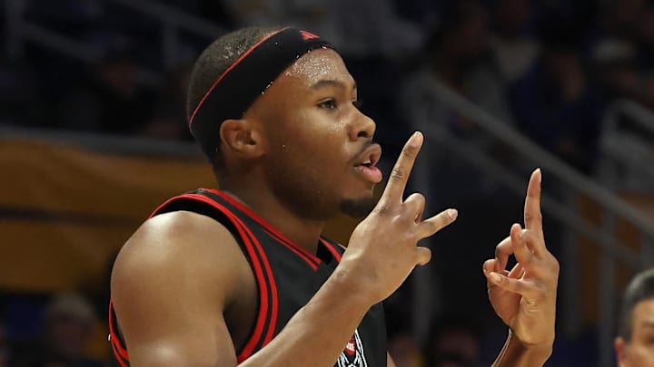 Jan 24, 2026; Pittsburgh, Pennsylvania, USA; NC State Wolfpack guard Tre Holloman (5) reacts after making a 3-point basket against the Pittsburgh Panthers during the first half at the Petersen Events Center. Mandatory Credit: Charles LeClaire-Imagn Images Jan 24, 2026; Pittsburgh, Pennsylvania, USA; NC State Wolfpack guard Tre Holloman (5) reacts after making a 3-point basket against the Pittsburgh Panthers during the first half at the Petersen Events Center. Mandatory Credit: Charles LeClaire-Imagn Images