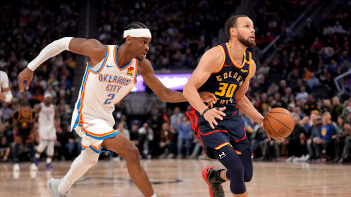 Jan 29, 2025; San Francisco, California, USA; Golden State Warriors guard Stephen Curry (30) dribbles past Oklahoma City Thunder guard Shai Gilgeous-Alexander (2) in the third quarter at the Chase Center. Mandatory Credit: Cary Edmondson-Imagn Images