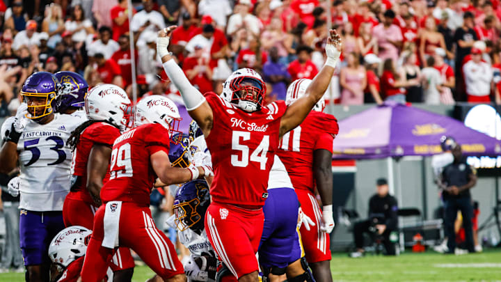 Aug 28, 2025; Raleigh, North Carolina, USA; North Carolina State Wolfpack defensive end Sabastian Harsh (54) celebrates a sack during the first half of the game against East Carolina Pirates at Carter-Finley Stadium. Mandatory Credit: Jaylynn Nash-Imagn Images Aug 28, 2025; Raleigh, North Carolina, USA; North Carolina State Wolfpack defensive end Sabastian Harsh (54) celebrates a sack during the first half of the game against East Carolina Pirates at Carter-Finley Stadium. Mandatory Credit: Jaylynn Nash-Imagn Images