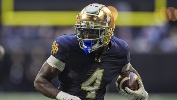 Oct 19, 2024; Atlanta, Georgia, USA; Notre Dame Fighting Irish running back Jeremiyah Love (4) runs against the Georgia Tech Yellow Jackets during the second half at Mercedes-Benz Stadium. \