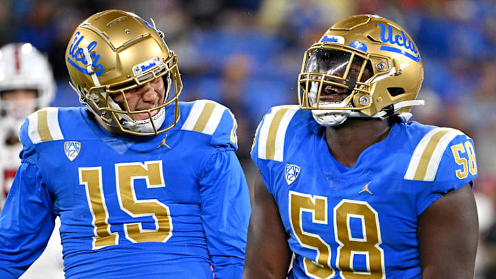 Oct 29, 2022; Pasadena, California, USA;  UCLA Bruins linebacker Laiatu Latu (15) and defensive lineman Gary Smith III (58) celebrate after a sack of Stanford Cardinal quarterback Tanner McKee (18)  in the first half at the Rose Bowl. Mandatory Credit: Jayne Kamin-Oncea-Imagn Images