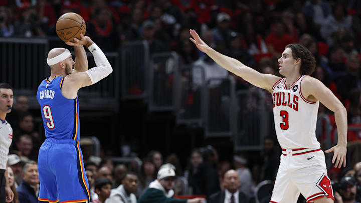 Oct 26, 2024; Chicago, Illinois, USA; Oklahoma City Thunder guard Alex Caruso (9) shoots against Chicago Bulls guard Josh Giddey (3) during the first half at United Center. Mandatory Credit: Kamil Krzaczynski-Imagn Images