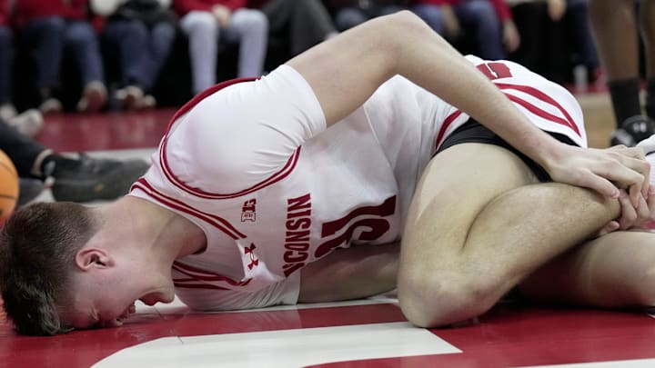 Wisconsin forward Nolan Winter (31) grabs his leg after being injured during the second half of their game Wednesday, March 4, 2026 at the Kohl Center in Madison, Wisconsin. Wisconsin beat Maryland 78-45.