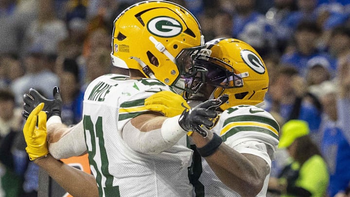 Green Bay Packers tight end Josh Whyle (81) and receiver Dontayvion Wicks (13) celebrate after a touchdown against the Lions.