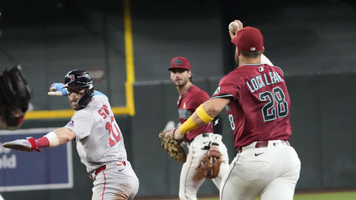 Boston Red Sox infielder Trevor Story (10) gets caught in a rundown by Arizona Diamondbacks first baseman Tyler Locklear (28) during the seventh inning at Chase Field on Sept. 7, 2025.