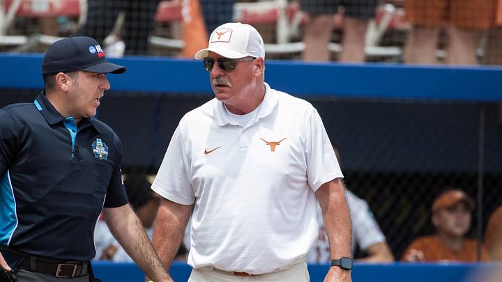 Texas Longhorns head coach Mike White talks to the home plate umpire in the sixth inning against the Tennessee Lady Volunteers. Texas Longhorns head coach Mike White talks to the home plate umpire in the sixth inning against the Tennessee Lady Volunteers.