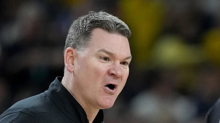 Arizona Wildcats head coach Tommy Lloyd talks with a referee Saturday, April 4, 2026, during a Final Four game against the Michigan Wolverines at Lucas Oil Stadium in Indianapolis.