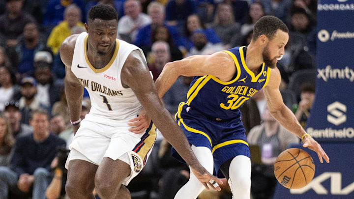 Apr 12, 2024; San Francisco, California, USA; Golden State Warriors guard Stephen Curry (30) dribbles away from pressure by New Orleans Pelicans forward Zion Williamson (1) during the second quarter at Chase Center. Mandatory Credit: D. Ross Cameron-Imagn Images