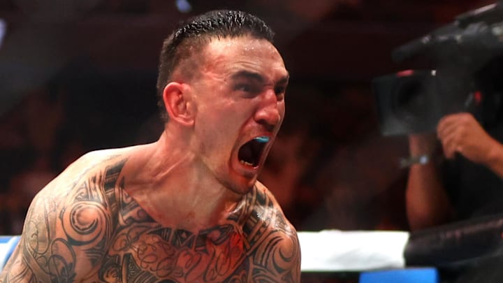 Apr 13, 2024; Las Vegas, Nevada, USA; Max Holloway (blue gloves) reacts after defeating Justin Gaethje (not pictured) during UFC 300 at T-Mobile Arena. Mandatory Credit: Mark J. Rebilas-Imagn Images