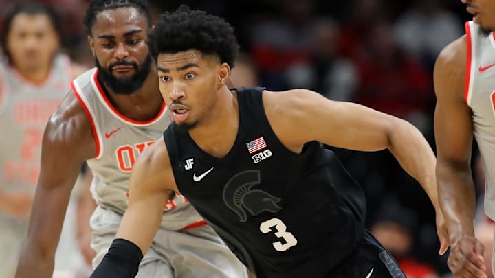 Jan 3, 2025; Columbus, Ohio, USA; Michigan State Spartans guard Jaden Akins (3) steals the ball from Ohio State Buckeyes guard Micah Parrish (8) and guard Evan Mahaffey (12) during the second half at Value City Arena. Mandatory Credit: Joseph Maiorana-Imagn Images