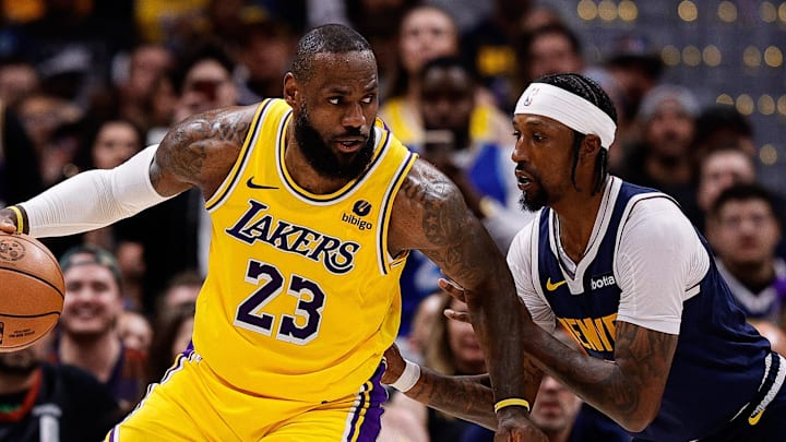 Apr 29, 2024; Denver, Colorado, USA; Los Angeles Lakers forward LeBron James (23) controls the ball as Denver Nuggets guard Kentavious Caldwell-Pope (5) guards in the third quarter during game five of the first round for the 2024 NBA playoffs at Ball Arena. 