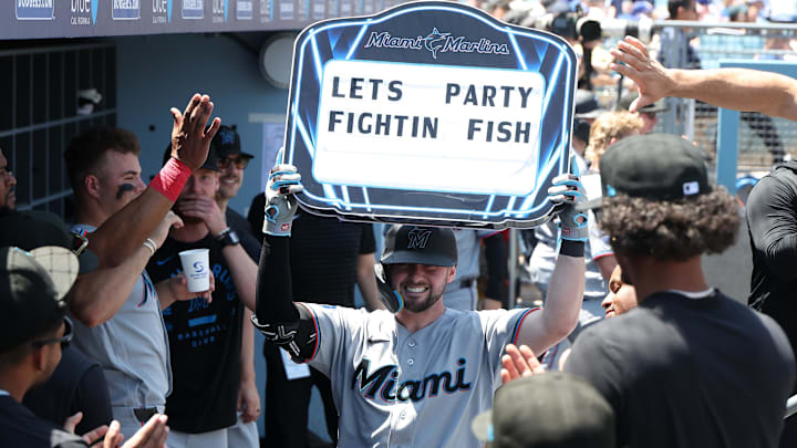 Miami Marlins catcher Liam Hicks (34) is congratulated in the dugout after hitting a solo home run. 