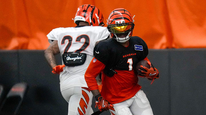 Cincinnati Bengals wide receiver Ja'Marr Chase (1) runs with a catch during a preseason training camp practice in downtown Cincinnati on Thursday, July 31, 2025. Cincinnati Bengals wide receiver Ja'Marr Chase (1) runs with a catch during a preseason training camp practice in downtown Cincinnati on Thursday, July 31, 2025.