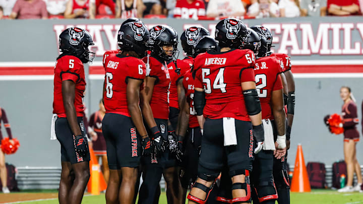 Sep 27, 2025; Raleigh, North Carolina, USA; North Carolina State Wolfpack huddle during the first half of the game against Virginia Tech Hokies at Carter-Finley Stadium. Mandatory Credit: Jaylynn Nash-Imagn Images Sep 27, 2025; Raleigh, North Carolina, USA; North Carolina State Wolfpack huddle during the first half of the game against Virginia Tech Hokies at Carter-Finley Stadium. Mandatory Credit: Jaylynn Nash-Imagn Images