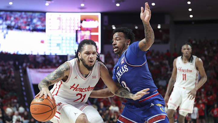 Mar 3, 2025; Houston, Texas, USA; Houston Cougars guard Emanuel Sharp (21) drives with the ball as Kansas Jayhawks guard David Coit (8) defends during the second half at Fertitta Center. Mar 3, 2025; Houston, Texas, USA; Houston Cougars guard Emanuel Sharp (21) drives with the ball as Kansas Jayhawks guard David Coit (8) defends during the second half at Fertitta Center.