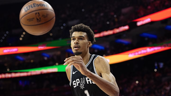 Dec 23, 2024; Philadelphia, Pennsylvania, USA; San Antonio Spurs center Victor Wembanyama (1) reaches for a loose ball against the Philadelphia 76ers during the first quarter at Wells Fargo Center.