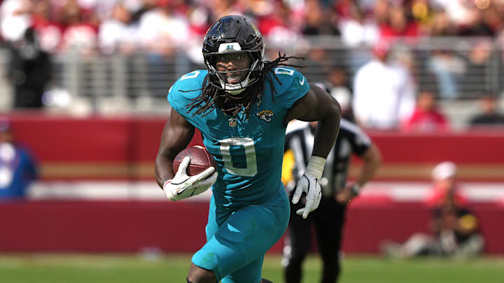 Sep 28, 2025; Santa Clara, California, USA; Jacksonville Jaguars linebacker Devin Lloyd (0) returns an interception against the San Francisco 49ers during the third quarter at Levi's Stadium. Mandatory Credit: Darren Yamashita-Imagn Images
