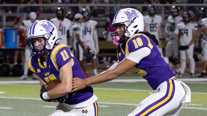Junior tailback Rio Arnett (11) takes a handoff from from fellow junior Boogie Anetema (19) during a 24-17 win over Gilbert Perry.
