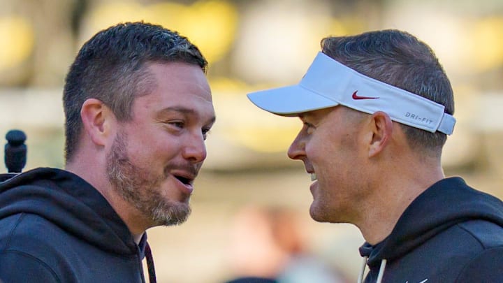 Oregon head coach Dan Lanning, left, and USC head coach Lincoln Riley shake hands before the game as the Oregon Ducks host the USC Trojans on Nov. 22, 2025, at Autzen Stadium in Eugene, Oregon.