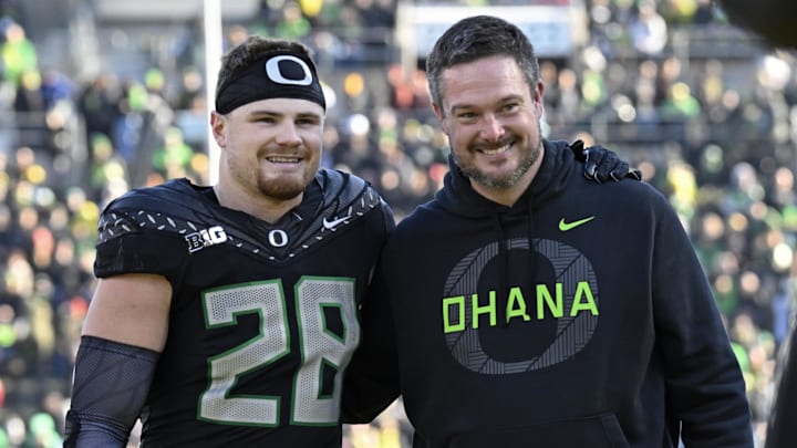 Nov 22, 2025; Eugene, Oregon, USA; Oregon Ducks linebacker Bryce Boettcher (28) poses for a photo head coach Dan Lanning before the game against the Southern California Trojans at Autzen Stadium. Mandatory Credit: Troy Wayrynen-Imagn Images