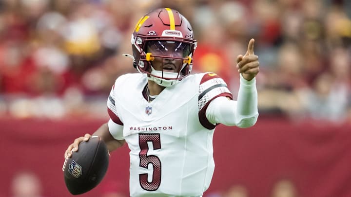 Sep 29, 2024; Glendale, Arizona, USA; Washington Commanders quarterback Jayden Daniels (5) runs the ball against the Arizona Cardinals in the first half at State Farm Stadium. Mandatory Credit: Mark J. Rebilas-Imagn Images