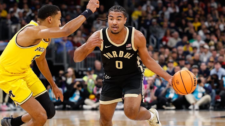 Purdue Boilermakers guard C.J. Cox (0) dribbles as Michigan Wolverines guard Nimari Burnett (4) defends.