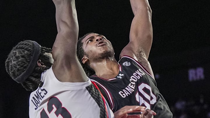 Jan 28, 2025; Athens, Georgia, USA; South Carolina Gamecocks forward Collin Murray-Boyles (30) dunks over Georgia Bulldogs forward Dylan James (13) during the second half at Stegeman Coliseum. Mandatory Credit: Dale Zanine-Imagn Images