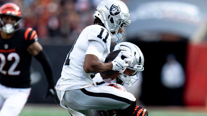 Cincinnati Bengals cornerback Mike Hilton (21) tackles Las Vegas Raiders wide receiver Tre Tucker (11) in the third quarter of the NFL game at Paycor Stadium in Cincinnati on Sunday, Nov. 3, 2024.