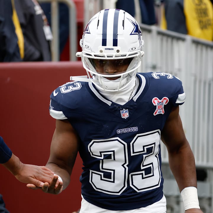 Dallas Cowboys running back Javonte Williams runs onto the field for warmups before a game against the Washington Commanders 
