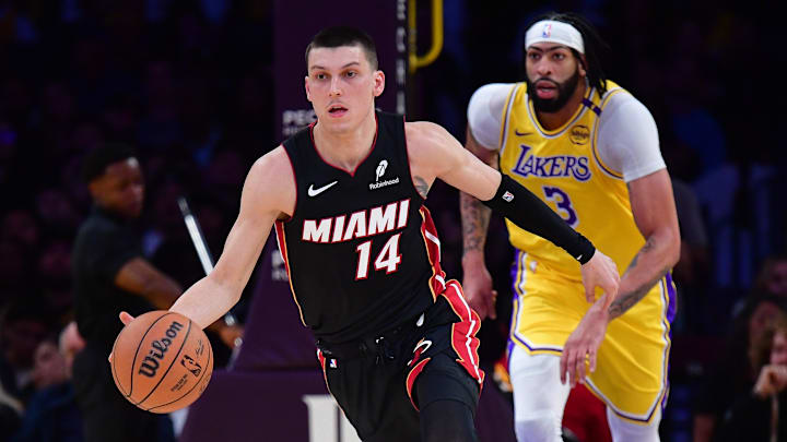 January 15, 2025; Los Angeles, California, USA; Miami Heat guard Tyler Herro (14) moves the ball up court ahead of Los Angeles Lakers forward Anthony Davis (3) during the first half at Crypto.com Arena. Mandatory Credit: Gary A. Vasquez-Imagn Images
