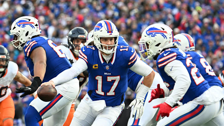 Buffalo Bills quarterback Josh Allen hands the ball off to running back Ty Johnson in a game. Buffalo Bills quarterback Josh Allen hands the ball off to running back Ty Johnson in a game.