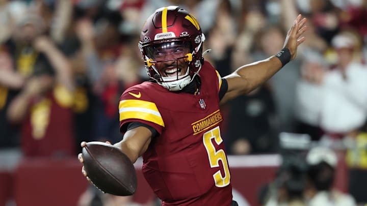 Aug 18, 2025; Landover, Maryland, USA; Washington Commanders quarterback Jayden Daniels (5) celebrates after scoring a touchdown against Cincinnati Bengals during the first half at Northwest Stadium. Mandatory Credit: Amber Searls-Imagn Images